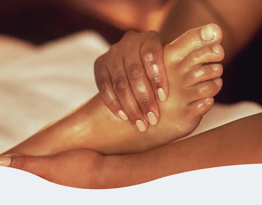 Close-up of a therapist giving someone a foot massage