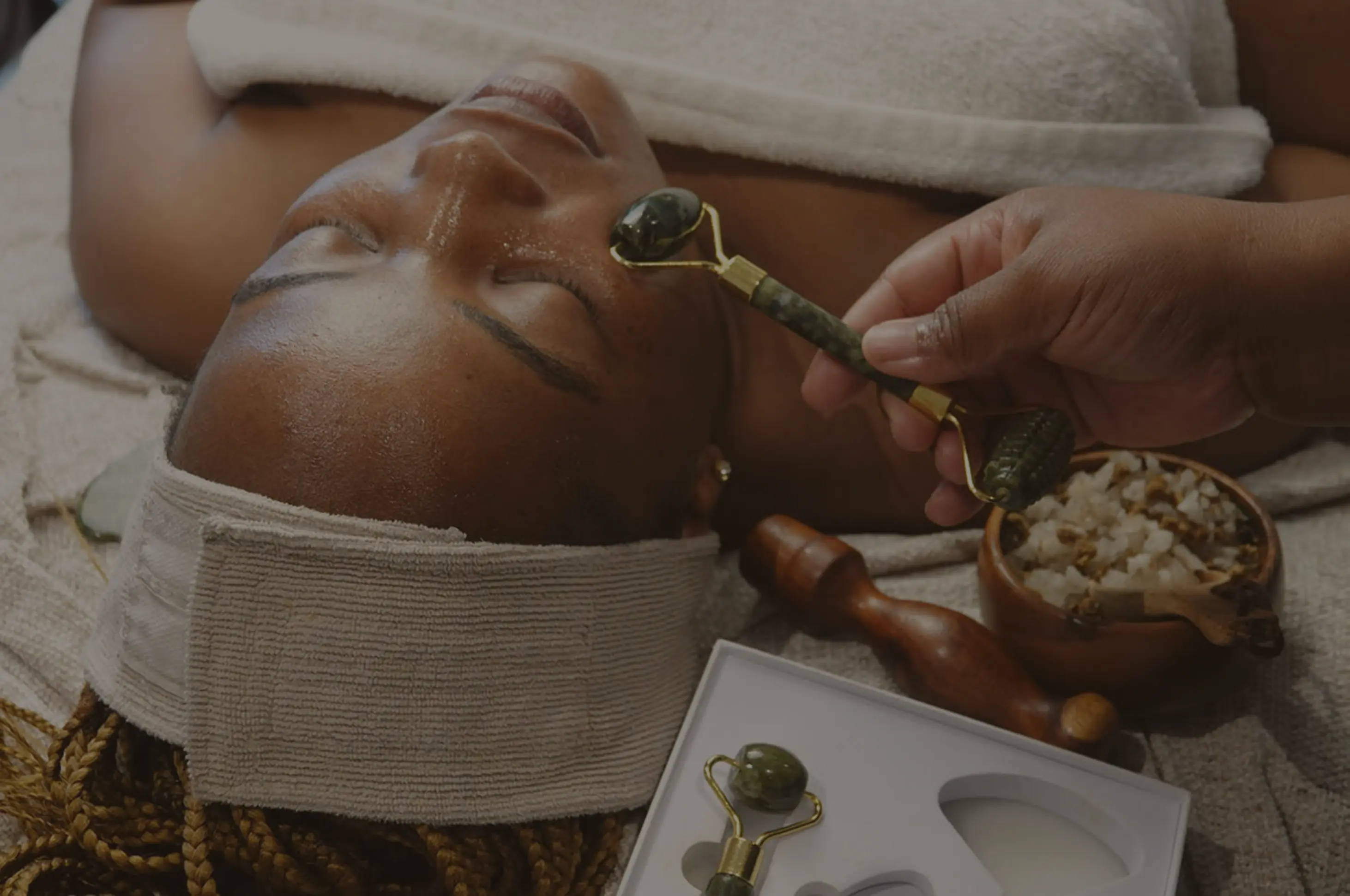 Picture of an african woman getting a facial massage at Pause Spa