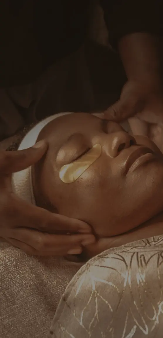 Picture of an african woman getting a facial massage at Pause Spa