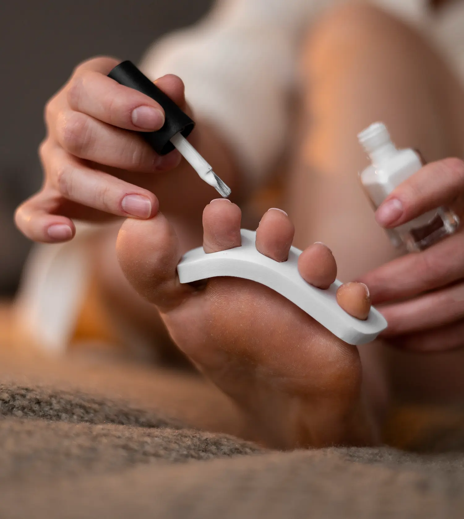 Therapist applying gel polish to a client's nails during her Pedicure & Gel Overlay experience at Pause Spa