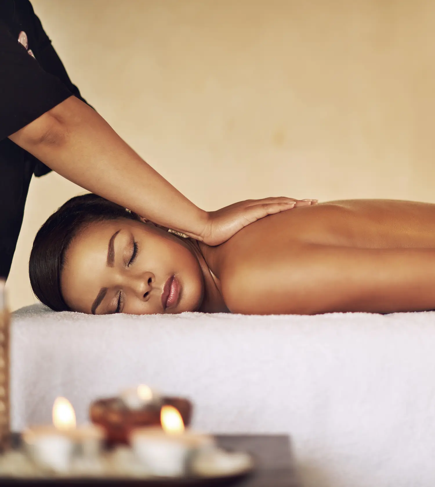 African woman enjoying a soothing lymph drainage massage during her Lymph Drainage experience at Pause Spa