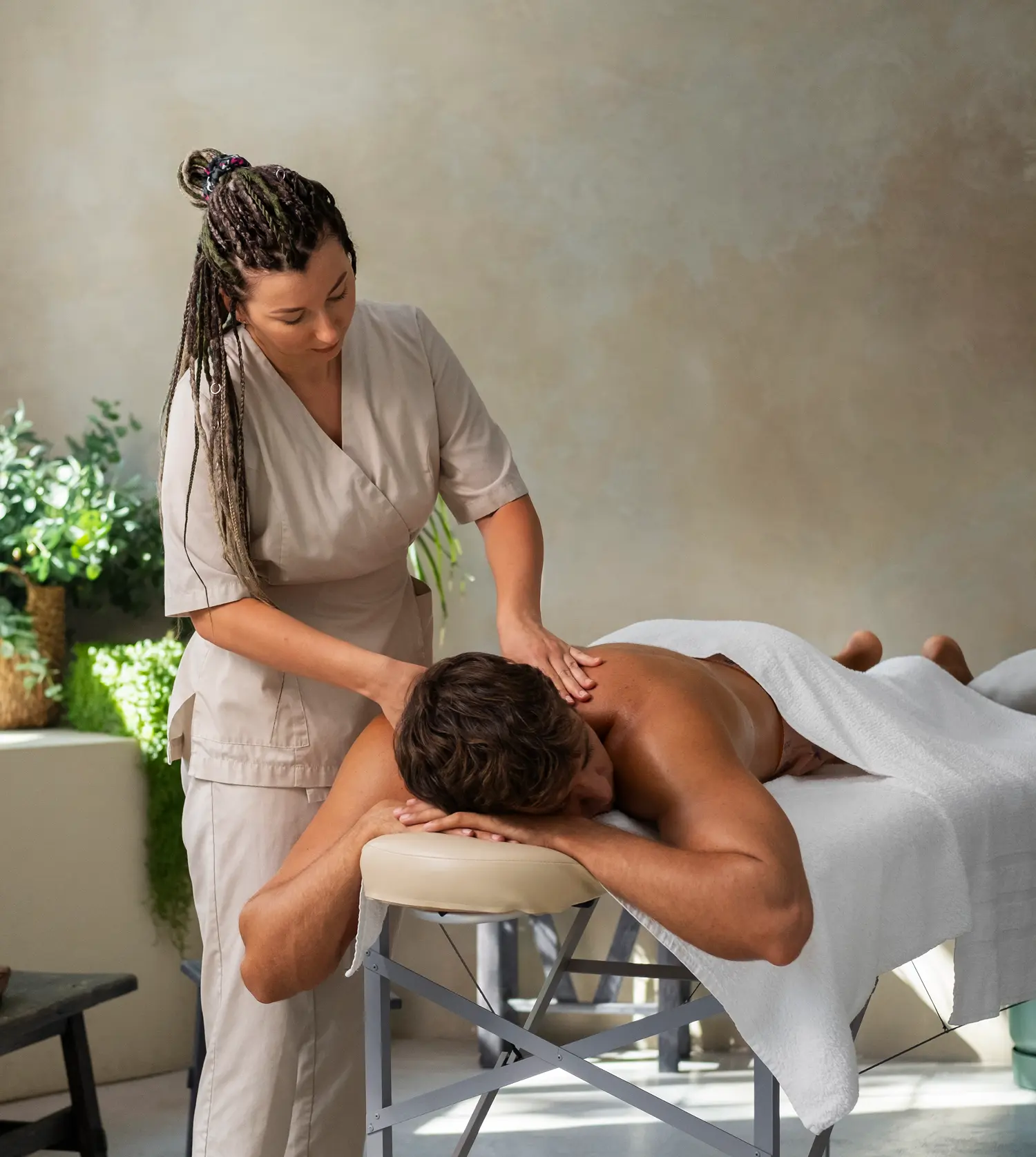 Indian man enjoying a relaxing back massage during his Full-Body Massage experience at Pause Spa