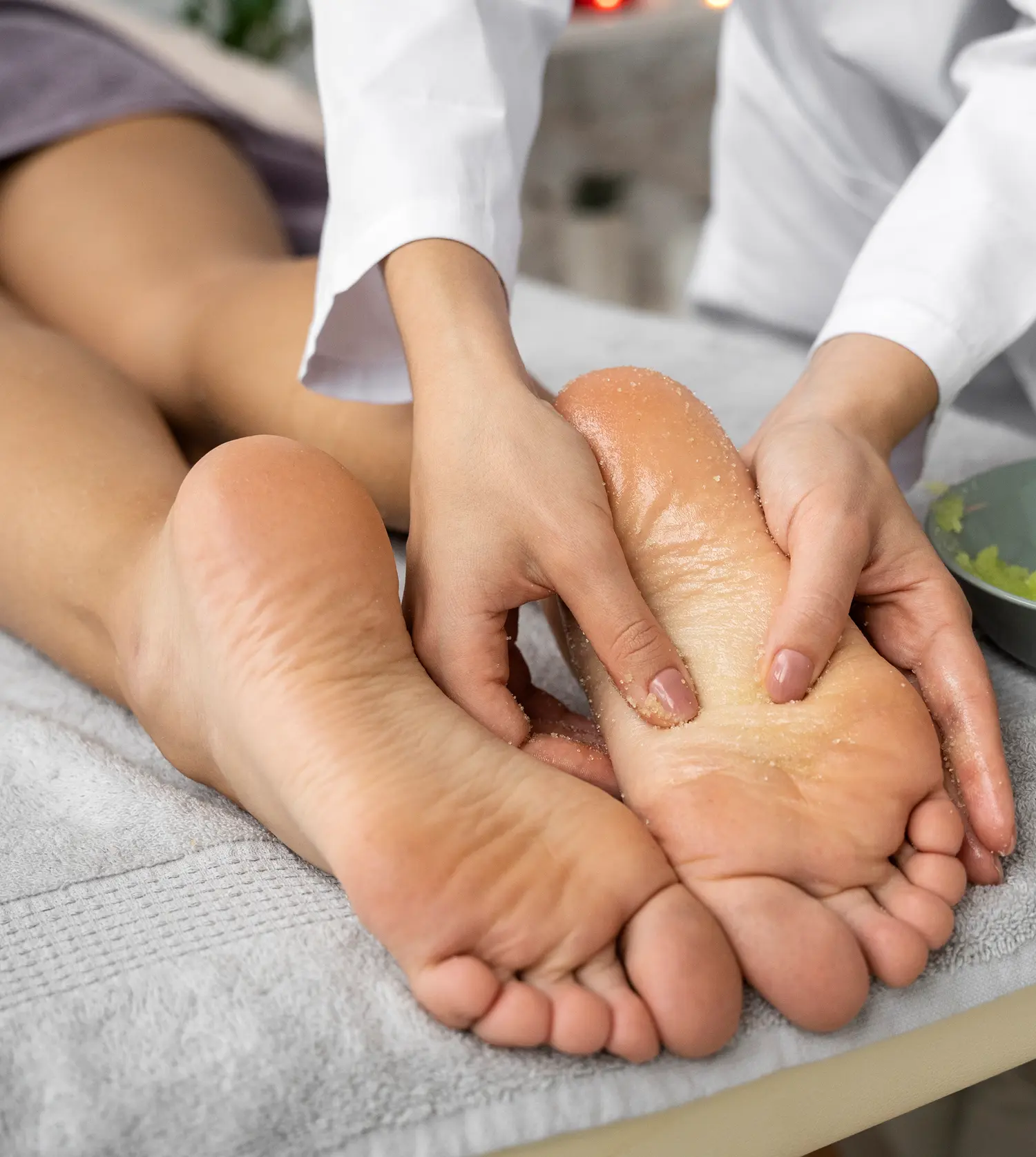 Therapist massaging a client's foot during her Thai Foot Massage experience at Pause Spa