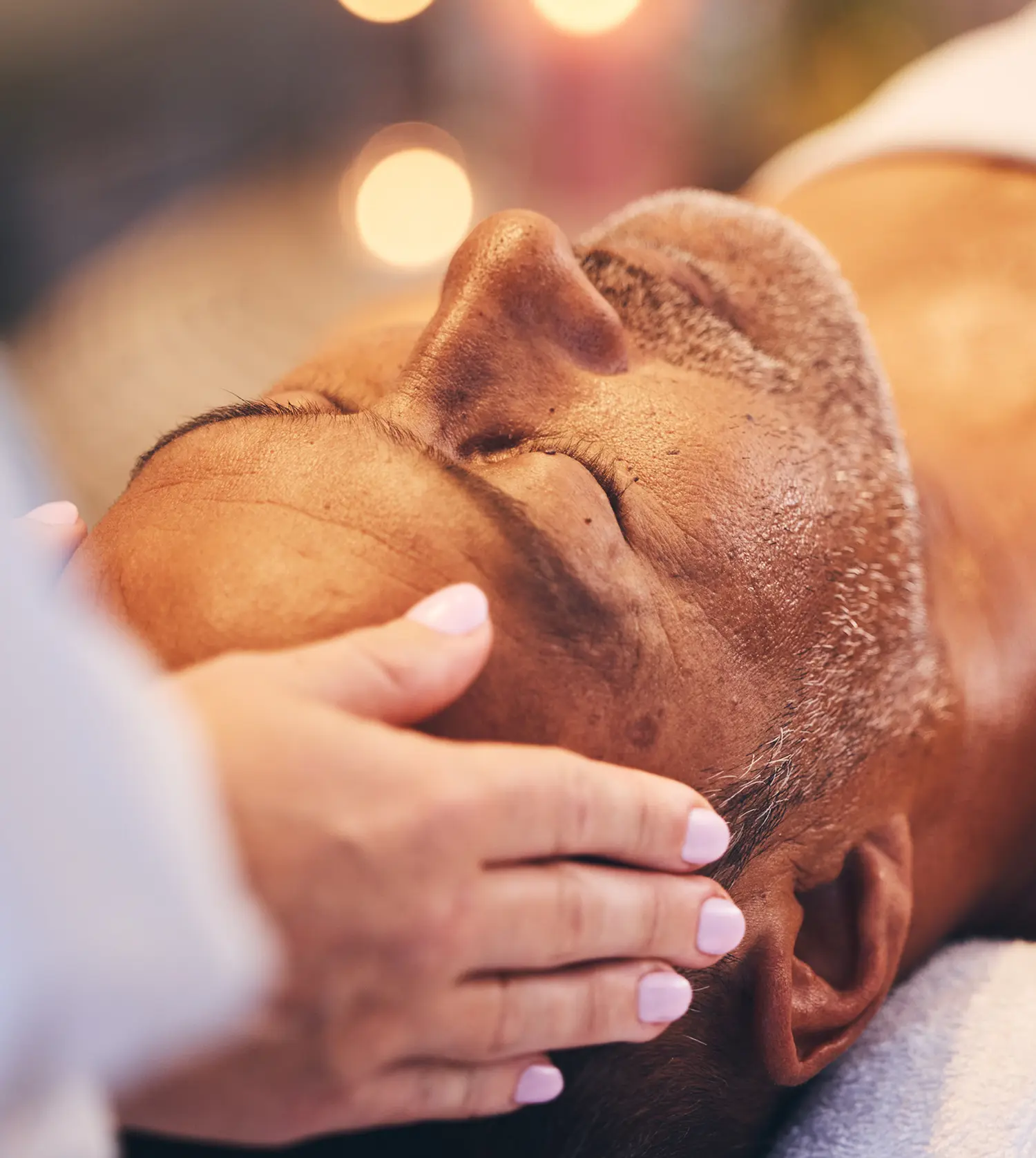 Man with white stubble beard enjoying a facial as part of his Men's Rejuvenating Spa Experience package at Pause Spa
