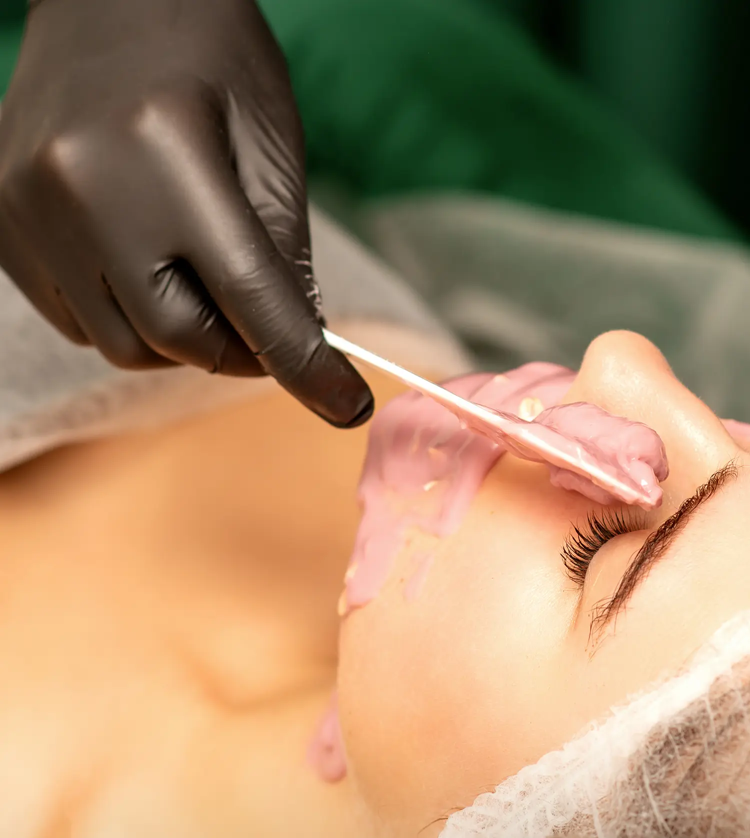 Therapist applying wax to a client's face during her Face Wax experience at Pause Spa